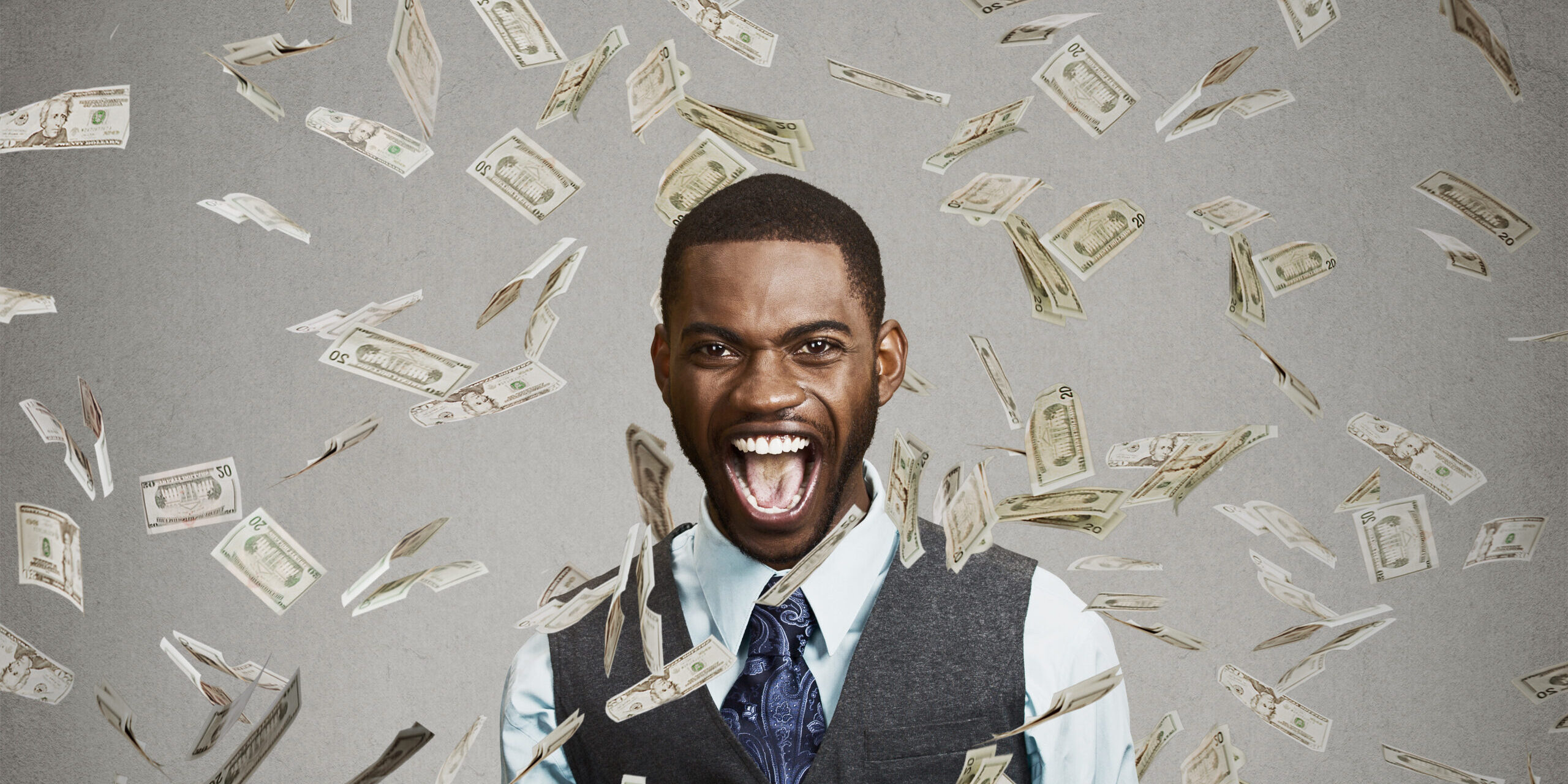 happy man pumping fists celebrates success under money rain