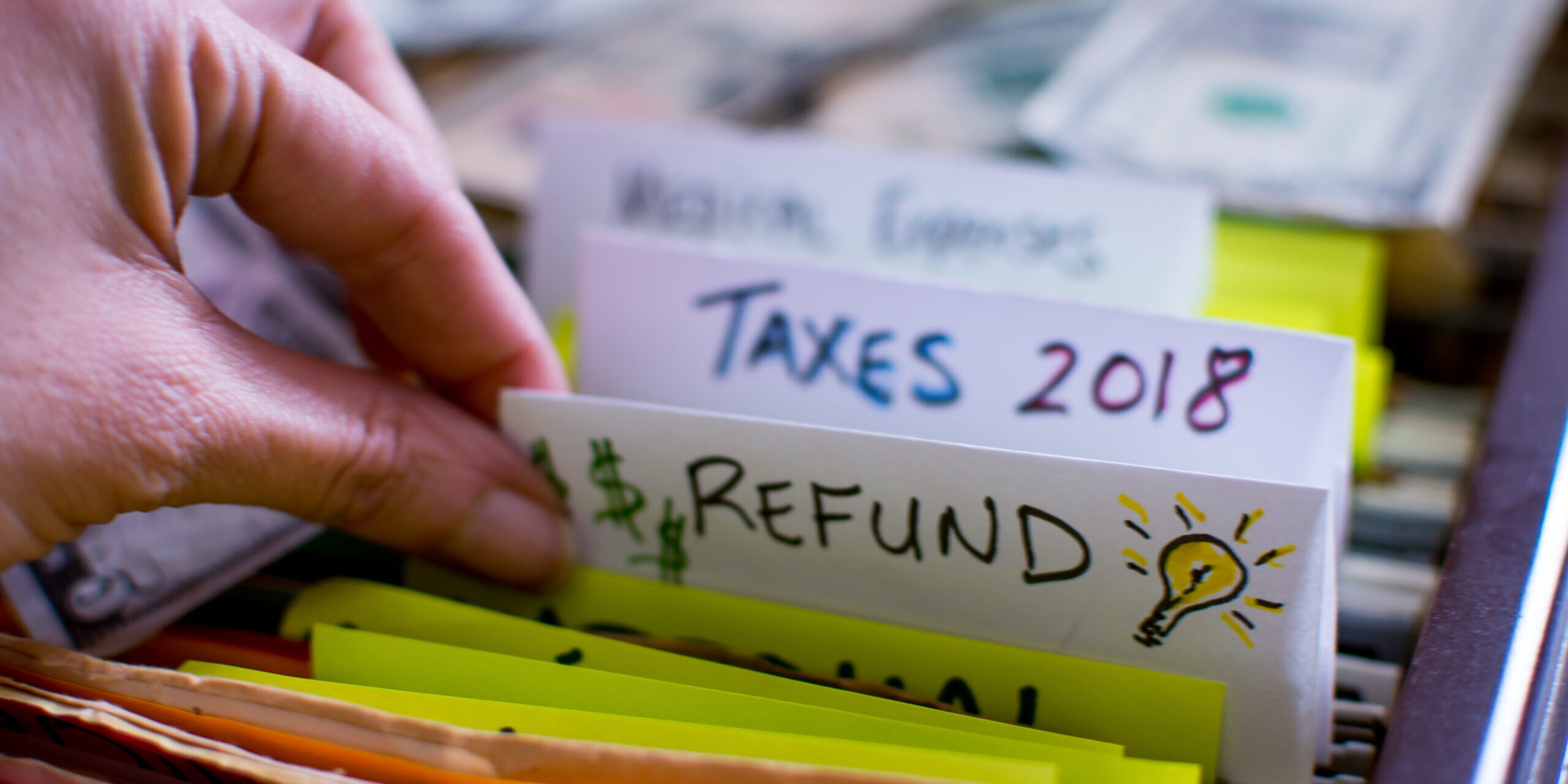 Woman pulling out file on Tax season 2018 Tax refund