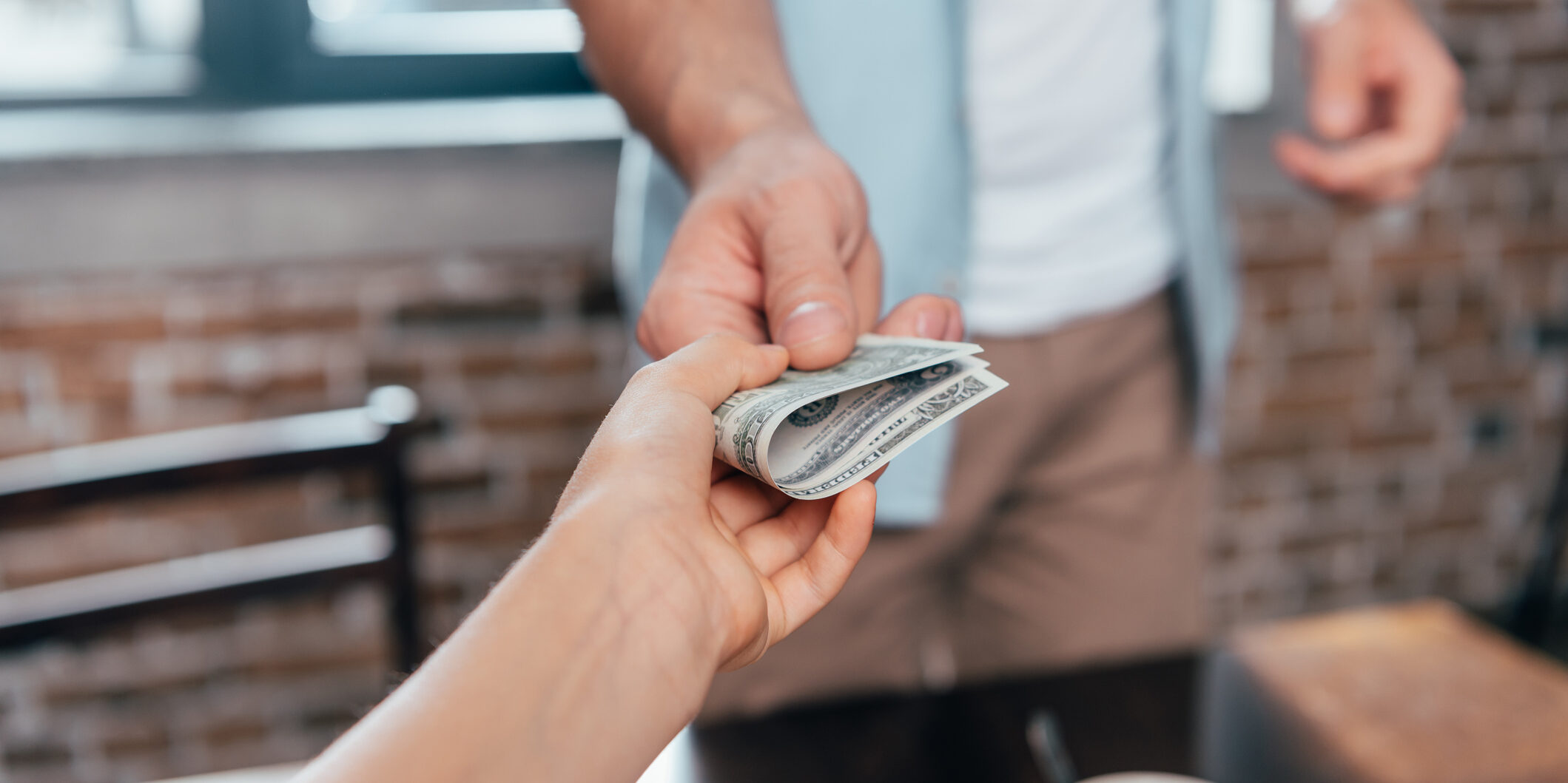 cropped shot of dad giving pocket money to daughter