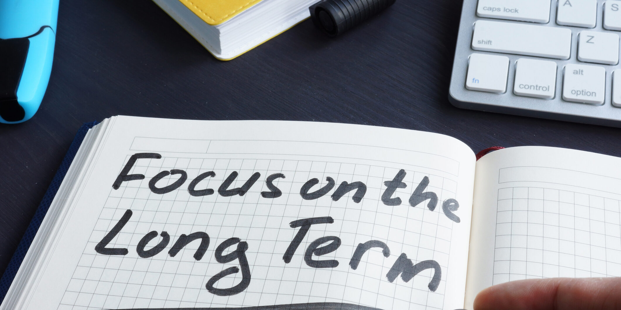 Man is writing focus on the long term.