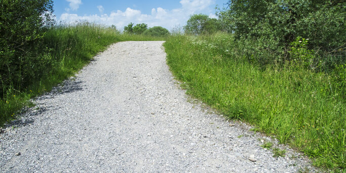 Uphill gravel road in summer