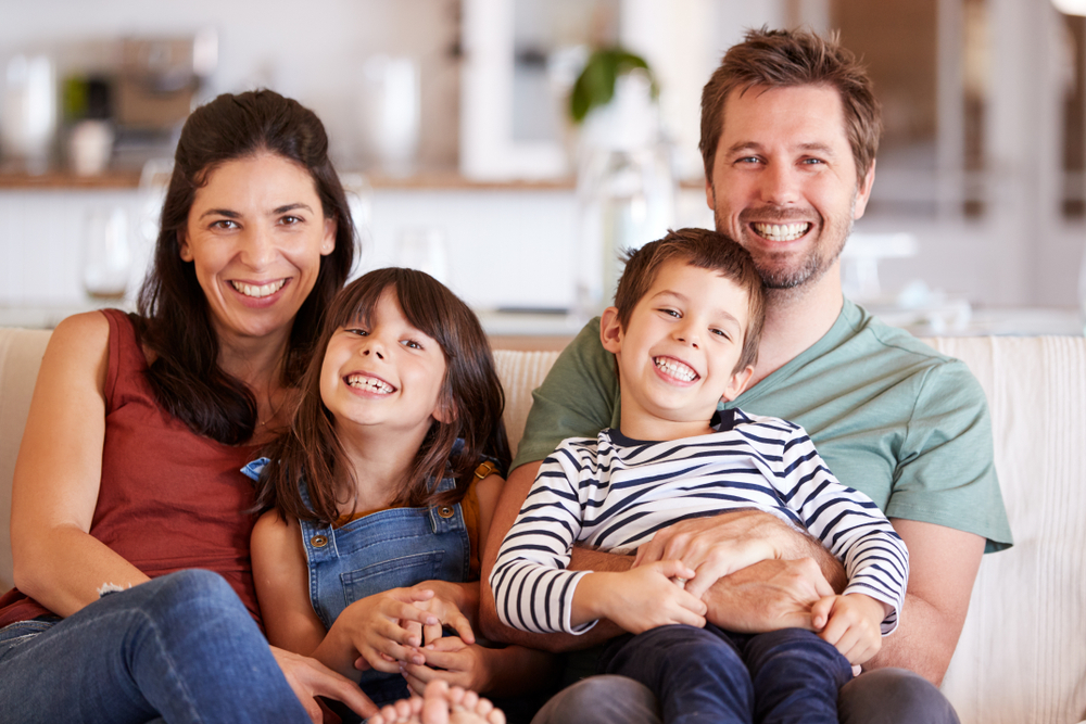 Mid,Adult,White,Couple,And,Their,Two,Young,Children,Sitting